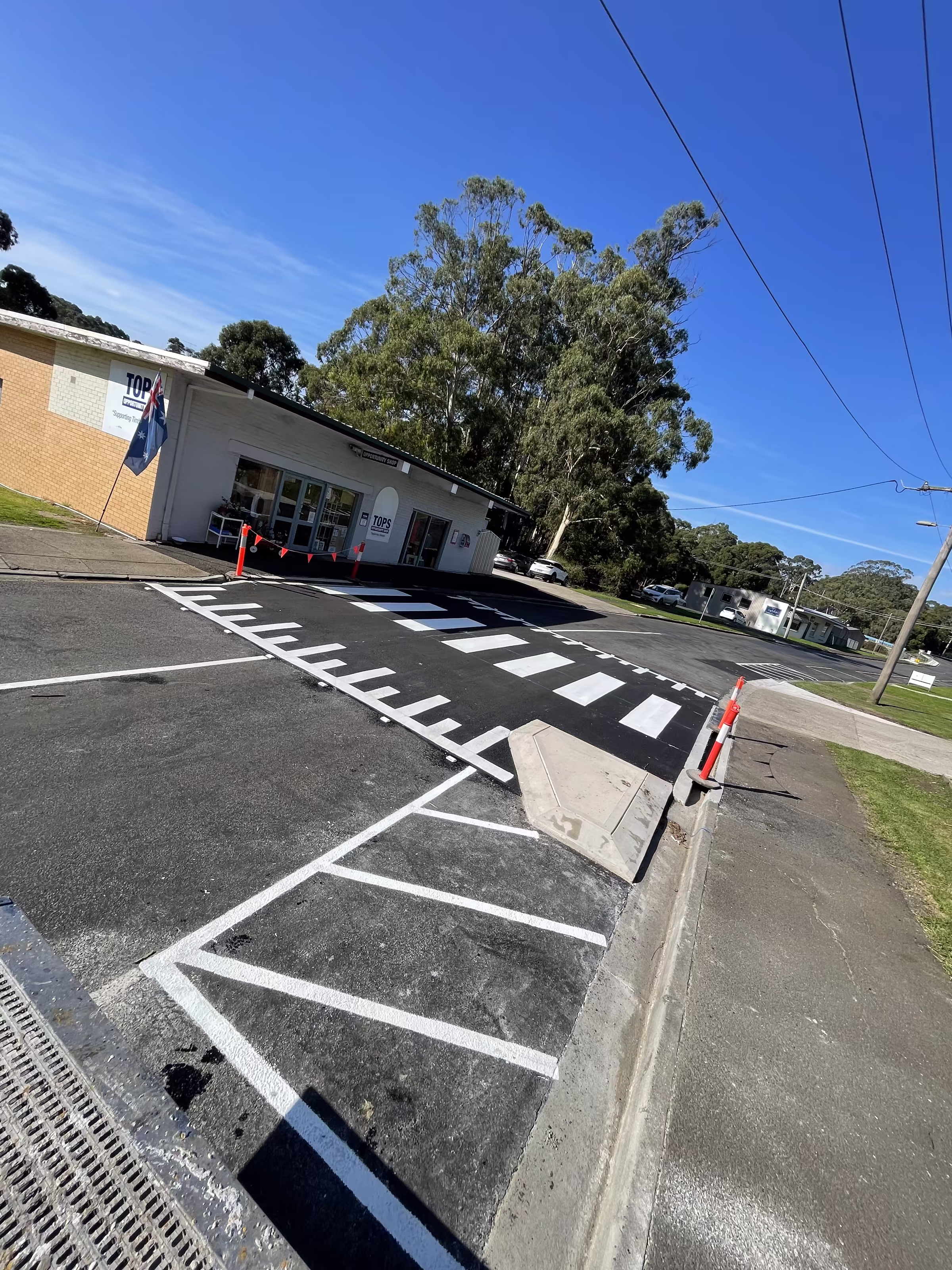 Fresh zebra crossing and parking bay markings outside a community building