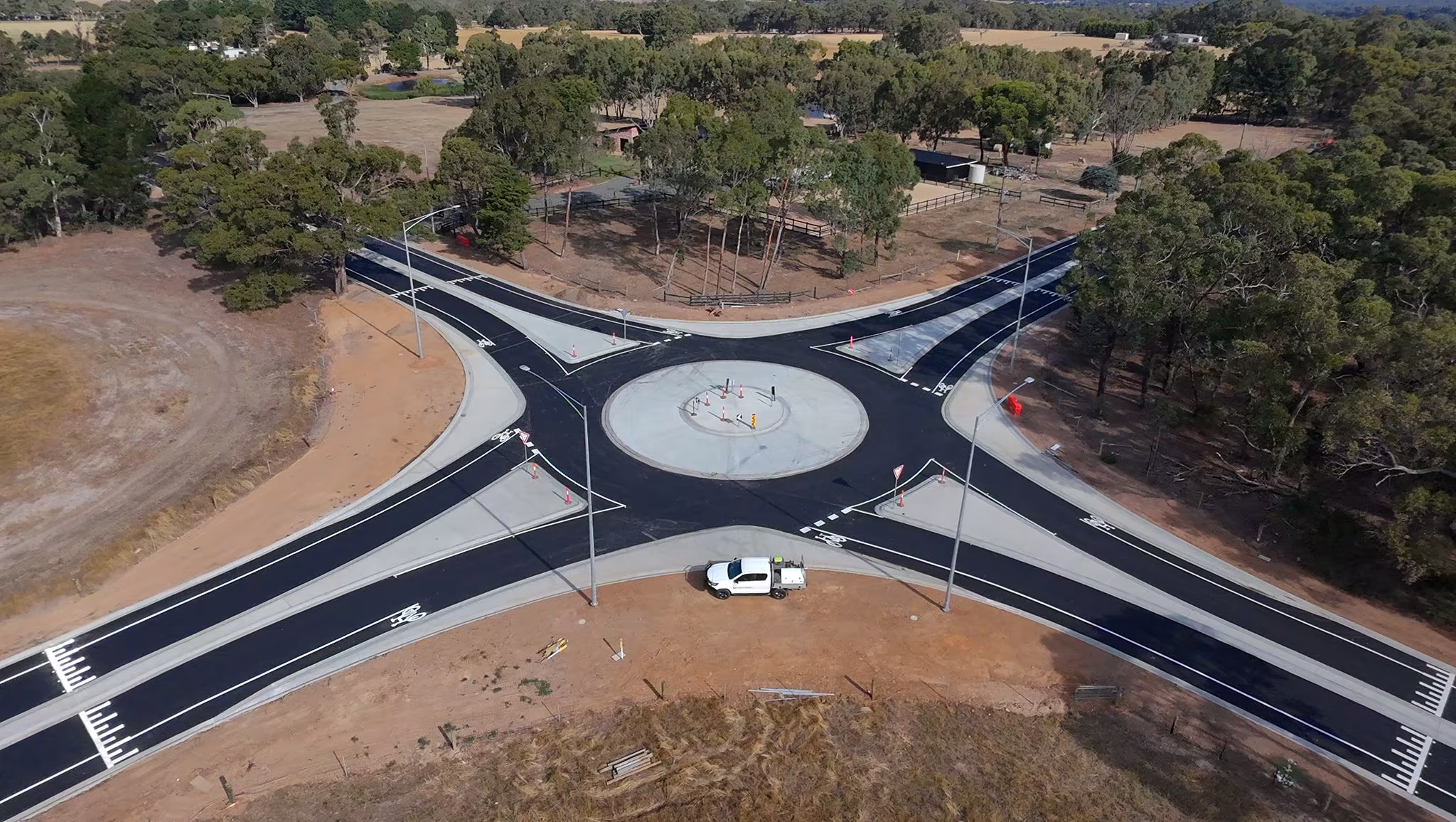 Aerial view of a newly marked rural roundabout with thermoplastic lane lines