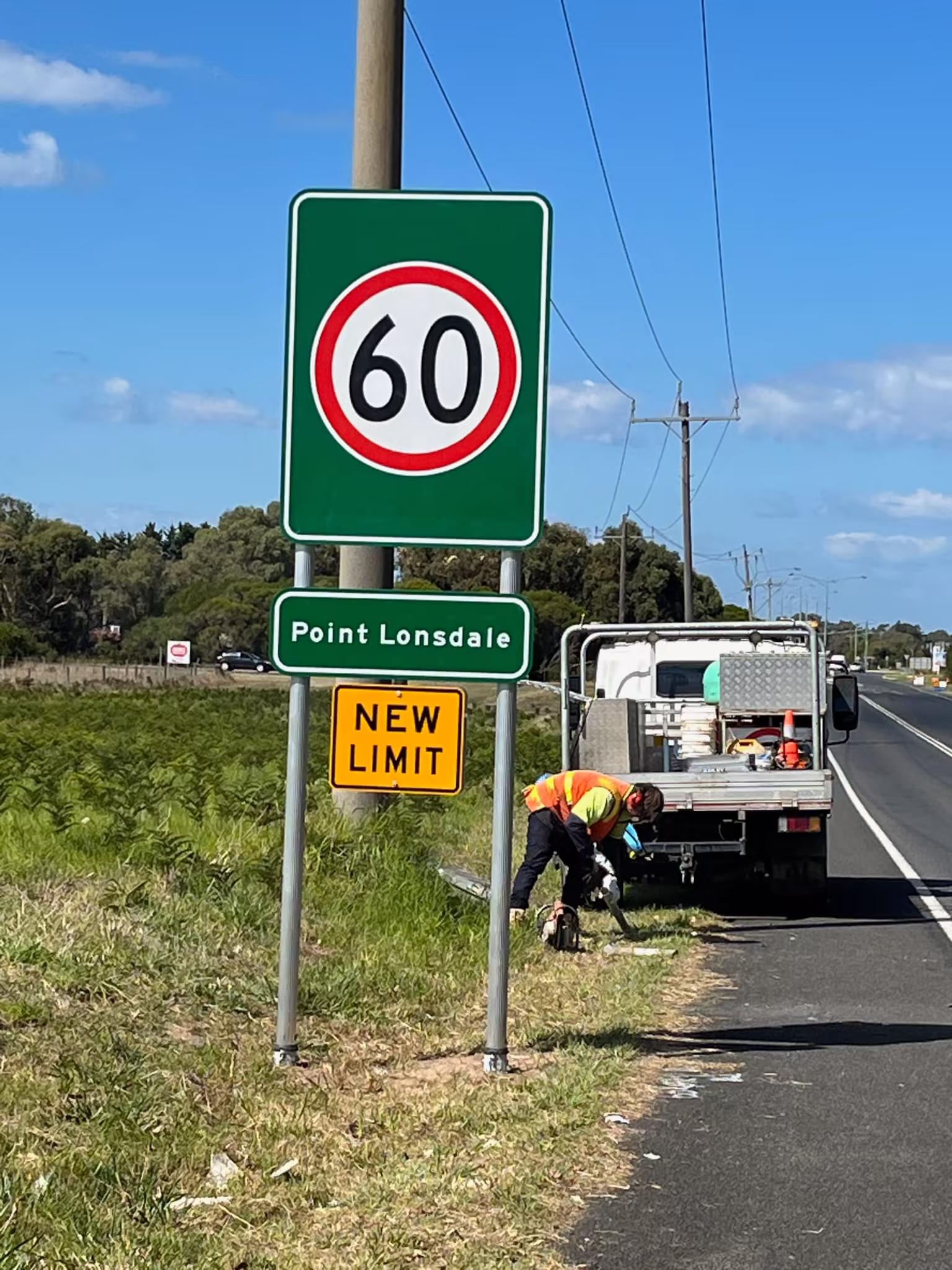 Crew installing a roadside sign