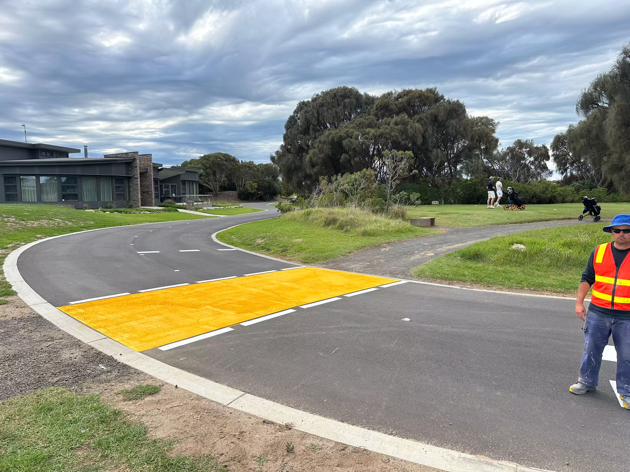 High-visibility yellow surface treatment across an access road